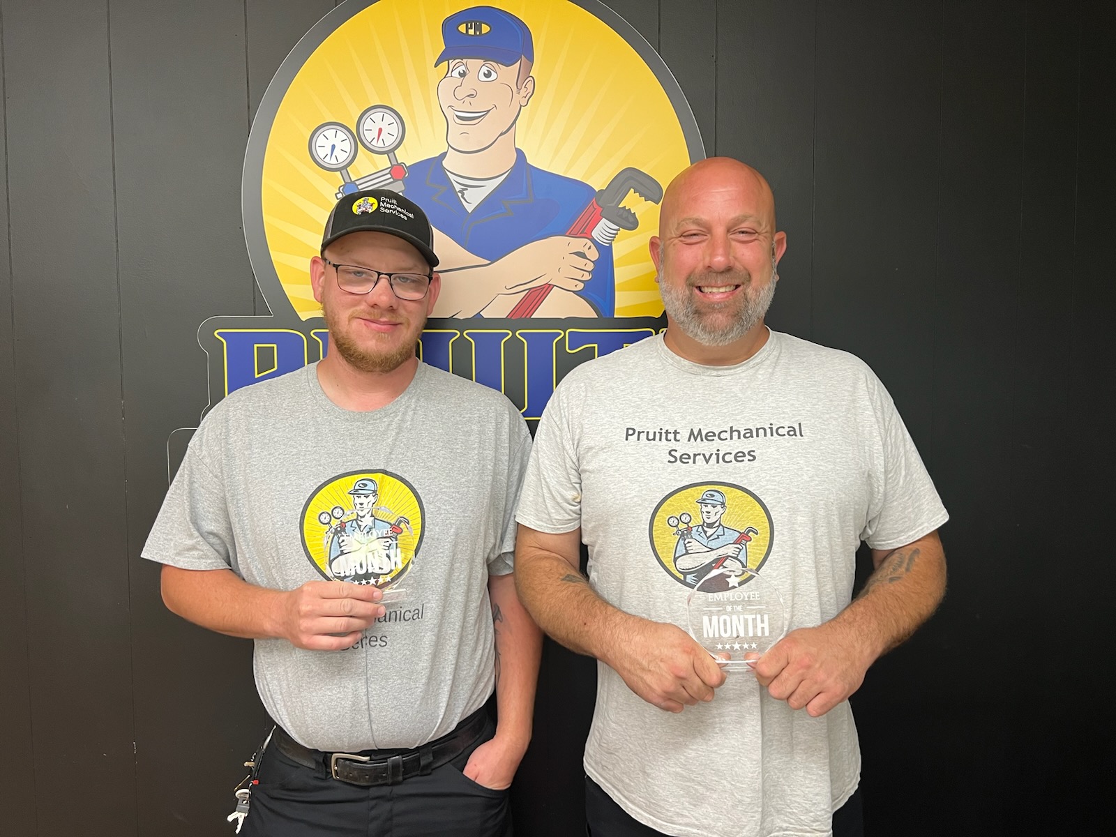 Team members with their employee of the month awards