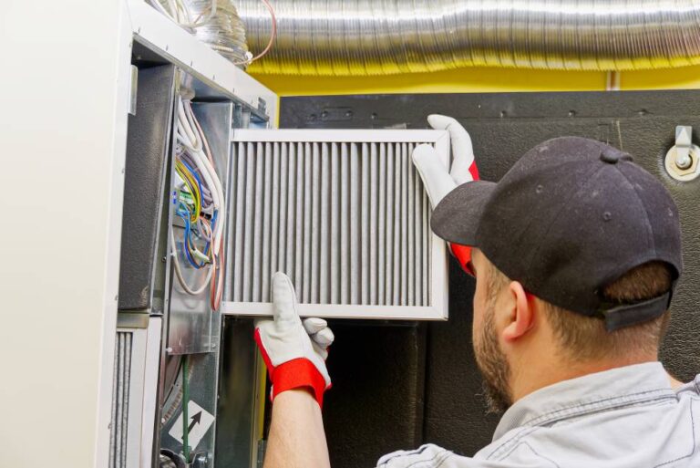 Technician changing a furnace filter